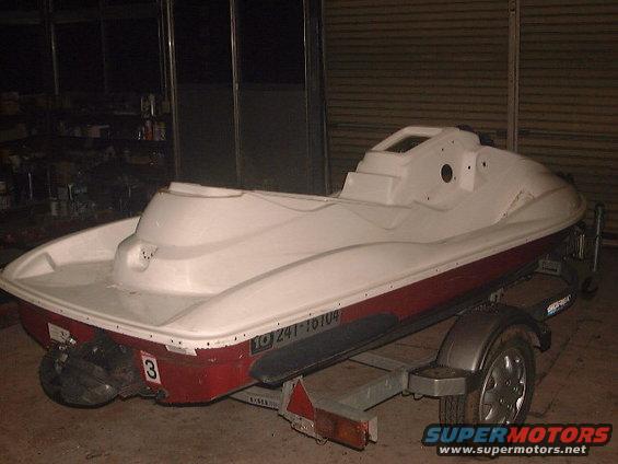 White and red personal watercraft on a trailer, seen from the rear. It has a number 3 on the back